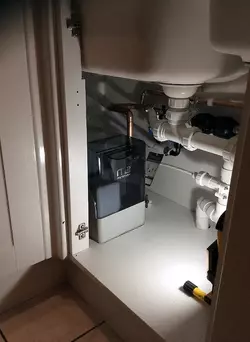 Tucking a softener in a corner cupboard can in fact be very effective
